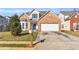 Charming two-story brick home with a well-manicured lawn and a two-car garage at 720 Goldenrod Way, Norcross, GA 30093