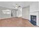 Spacious living room with hardwood floors, fireplace, and open access to other rooms at 720 Goldenrod Way, Norcross, GA 30093