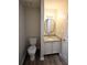 Cozy half bathroom with modern granite vanity and wood look flooring at 184 Brandywine Dr, Douglasville, GA 30134