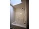 Bright bathroom featuring a shower and tub combination with a skylight above at 184 Brandywine Dr, Douglasville, GA 30134