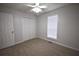 Bedroom featuring neutral walls, carpet, ceiling fan, window and closet at 184 Brandywine Dr, Douglasville, GA 30134