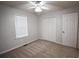 Bedroom featuring neutral walls, carpet, ceiling fan, window and closet at 184 Brandywine Dr, Douglasville, GA 30134