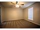 Neutral bedroom with carpet, a ceiling fan, and a window providing natural light at 184 Brandywine Dr, Douglasville, GA 30134