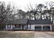 Traditional single-story home with a two-car garage, covered porch, and neutral color palette at 184 Brandywine Dr, Douglasville, GA 30134