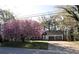 Inviting single-story home with a two-car garage and a beautiful blooming tree in the front at 184 Brandywine Dr, Douglasville, GA 30134