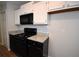 Updated kitchen featuring granite countertops and sleek black appliances at 184 Brandywine Dr, Douglasville, GA 30134