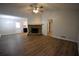 Open concept living room with stone fireplace, hardwood flooring and ceiling fan at 184 Brandywine Dr, Douglasville, GA 30134