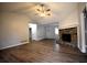 Open-concept living room with wood flooring and a charming stone fireplace at 184 Brandywine Dr, Douglasville, GA 30134