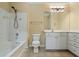 Bright bathroom featuring a bathtub, shower, toilet, vanity with cabinets, and large mirror at 1850 Cotillion Dr # 3222, Atlanta, GA 30338