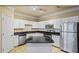 Well-lit kitchen with white cabinetry, granite countertops and stainless steel appliances at 1850 Cotillion Dr # 3222, Atlanta, GA 30338