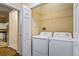 Convenient laundry room featuring a washer and dryer set, and extra shelving at 1850 Cotillion Dr # 3222, Atlanta, GA 30338