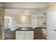 Open concept living room with view of the kitchen, wood floors and classic style white trim at 1850 Cotillion Dr # 3222, Atlanta, GA 30338