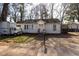 Modest single-story home with white siding and small front porch with a truck parked in front at 241 Killian St, Canton, GA 30114