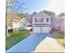 Charming two-story home featuring a two-car garage and well-maintained lawn at 3466 Carriage Chase Rd, Atlanta, GA 30349