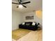 Inviting living room features a modern ceiling fan and comfortable leather sofa at 3466 Carriage Chase Rd, Atlanta, GA 30349