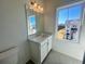 Bright bathroom with a white vanity, large mirror, and window at 522 Healy Dr # 66, Cumming, GA 30040