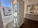 Bright bathroom with a pedestal sink and view of a neighborhood outside a large window at 522 Healy Dr # 66, Cumming, GA 30040