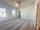 Bright bedroom with plush carpet, large windows, and a ceiling fan for comfort at 522 Healy Dr # 66, Cumming, GA 30040