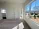 Sunlit bedroom with large windows, plush carpet, and access to a private bathroom at 522 Healy Dr # 66, Cumming, GA 30040