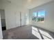 Bright bedroom featuring a large window, closet, and neutral carpet at 522 Healy Dr # 66, Cumming, GA 30040