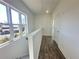 Hallway with access to stairs, natural lighting, and wood flooring at 522 Healy Dr # 66, Cumming, GA 30040