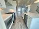 Open-concept kitchen boasts stainless appliances, long countertops, with views to the living area and fireplace at 522 Healy Dr # 66, Cumming, GA 30040