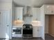 Modern kitchen featuring stainless steel appliances, white cabinets, quartz countertops and a tile backsplash at 522 Healy Dr # 66, Cumming, GA 30040