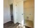 Well-lit laundry room with tile floors and a wire shelving unit for storage at 522 Healy Dr # 66, Cumming, GA 30040