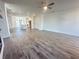 Open living space with hardwood floors flows into a modern kitchen with a central island and sleek appliances at 522 Healy Dr # 66, Cumming, GA 30040