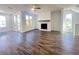 Inviting living room with fireplace, ceiling fan, hardwood floors, and bright windows that fill the space at 522 Healy Dr # 66, Cumming, GA 30040