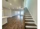 View of the open living room and staircase with hardwood floors and natural light at 522 Healy Dr # 66, Cumming, GA 30040