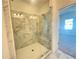 Bright, modern shower with marble tiling, a built-in seat, and frameless glass door at 522 Healy Dr # 66, Cumming, GA 30040