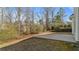 Backyard patio area perfect for outdoor entertaining, surrounded by trees, shrubbery and lush greenery at 5706 Spring Mill Cir, Lithonia, GA 30038