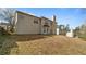 Spacious backyard with a well-maintained lawn, a neutral exterior, and mature trees surrounding the property at 5706 Spring Mill Cir, Lithonia, GA 30038