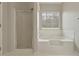 This bathroom has a shower, a bathtub, tile floors, and a window at 5706 Spring Mill Cir, Lithonia, GA 30038