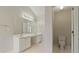 Bright bathroom showcases a dual sink vanity, a large mirror, and tile floor at 5706 Spring Mill Cir, Lithonia, GA 30038