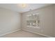 Well-lit bedroom featuring neutral walls, plush carpet and a window at 5706 Spring Mill Cir, Lithonia, GA 30038