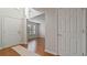 Bright foyer featuring hardwood floors, neutral paint, and a view into an adjacent room with natural light at 5706 Spring Mill Cir, Lithonia, GA 30038