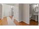 Bright foyer with hardwood floors, a half bathroom on the right, and a view of the staircase leading upstairs at 5706 Spring Mill Cir, Lithonia, GA 30038