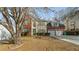 Charming two-story home with a brick and siding facade, green shutters, attached two-car garage, and mature trees at 5706 Spring Mill Cir, Lithonia, GA 30038