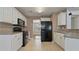 Modern kitchen with white cabinetry, black appliances, and granite countertops at 5706 Spring Mill Cir, Lithonia, GA 30038