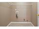 Functional laundry room with tile flooring, convenient utility connections, and storage shelving at 5706 Spring Mill Cir, Lithonia, GA 30038