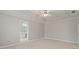 Large primary bedroom boasts neutral walls, carpeting, and ensuite bathroom access at 5706 Spring Mill Cir, Lithonia, GA 30038