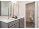 Bathroom featuring double sinks and a view into the walk-in closet at 1465 Auburn Glen Rd, Dacula, GA 30019