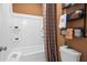 Bathroom featuring a shower-tub combination, tile surround, dark trim and towel rack at 1465 Auburn Glen Rd, Dacula, GA 30019