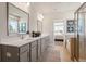 Stylish bathroom featuring a double sink vanity, shower, and well-lit mirror at 1465 Auburn Glen Rd, Dacula, GA 30019