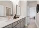 Modern bathroom featuring double sinks and an open doorway at 1465 Auburn Glen Rd, Dacula, GA 30019
