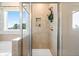 Modern shower features sleek glass doors, neutral tile, and a convenient built-in niche at 1465 Auburn Glen Rd, Dacula, GA 30019
