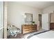 Staged bedroom with a wooden dresser and view of the ensuite bathroom at 1465 Auburn Glen Rd, Dacula, GA 30019