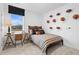 Nicely decorated bedroom with natural light, plaid bedding, and football decor at 1465 Auburn Glen Rd, Dacula, GA 30019